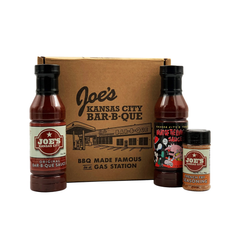 A gift box labeled Joe's Kansas City Bar-B-Que with a bottle of BBQ sauce, a bottle of hot sauce, and a container of fry seasoning.
